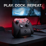 GameSir G7 Pro black and red controller on a charging dock at a gaming desk
